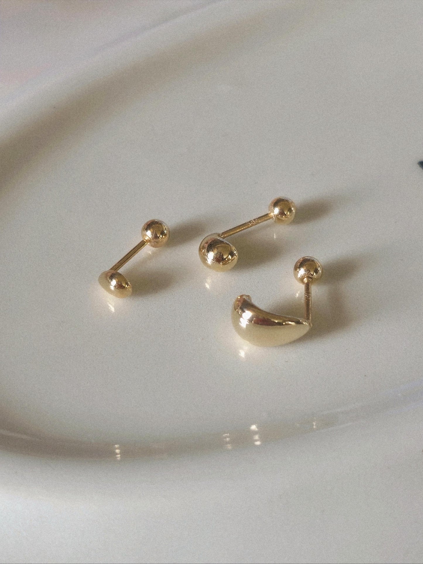 14k solid gold Teardrop screwball piercing. Teardrop piercing.