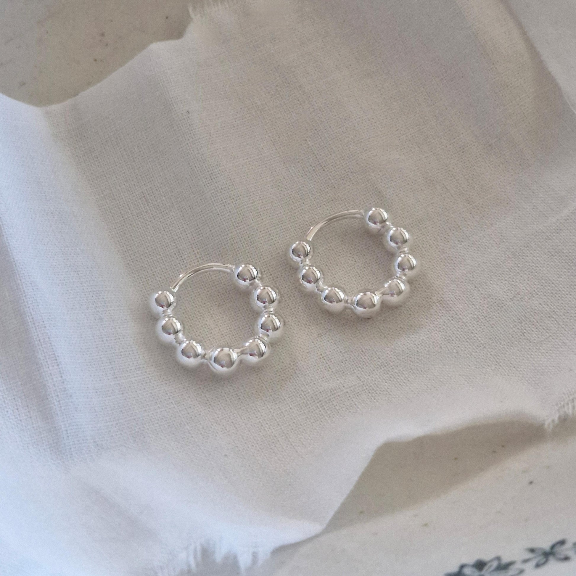 Bubble earrings. Basic hoop ball plain huggie earrings simple and chic. modernist design. clicker.