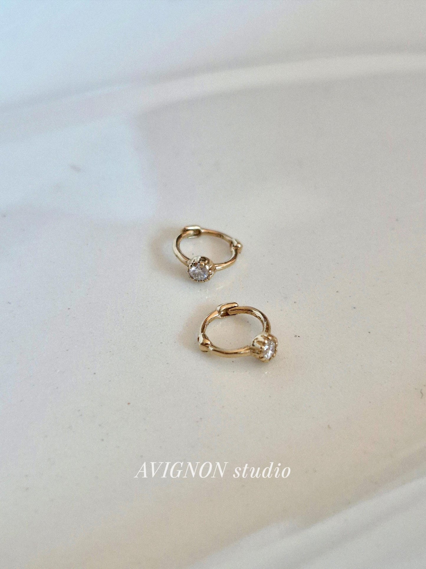 Tiny moisanite lab diamond 14k hoop earring.  solid gold hoop hinged clicker.