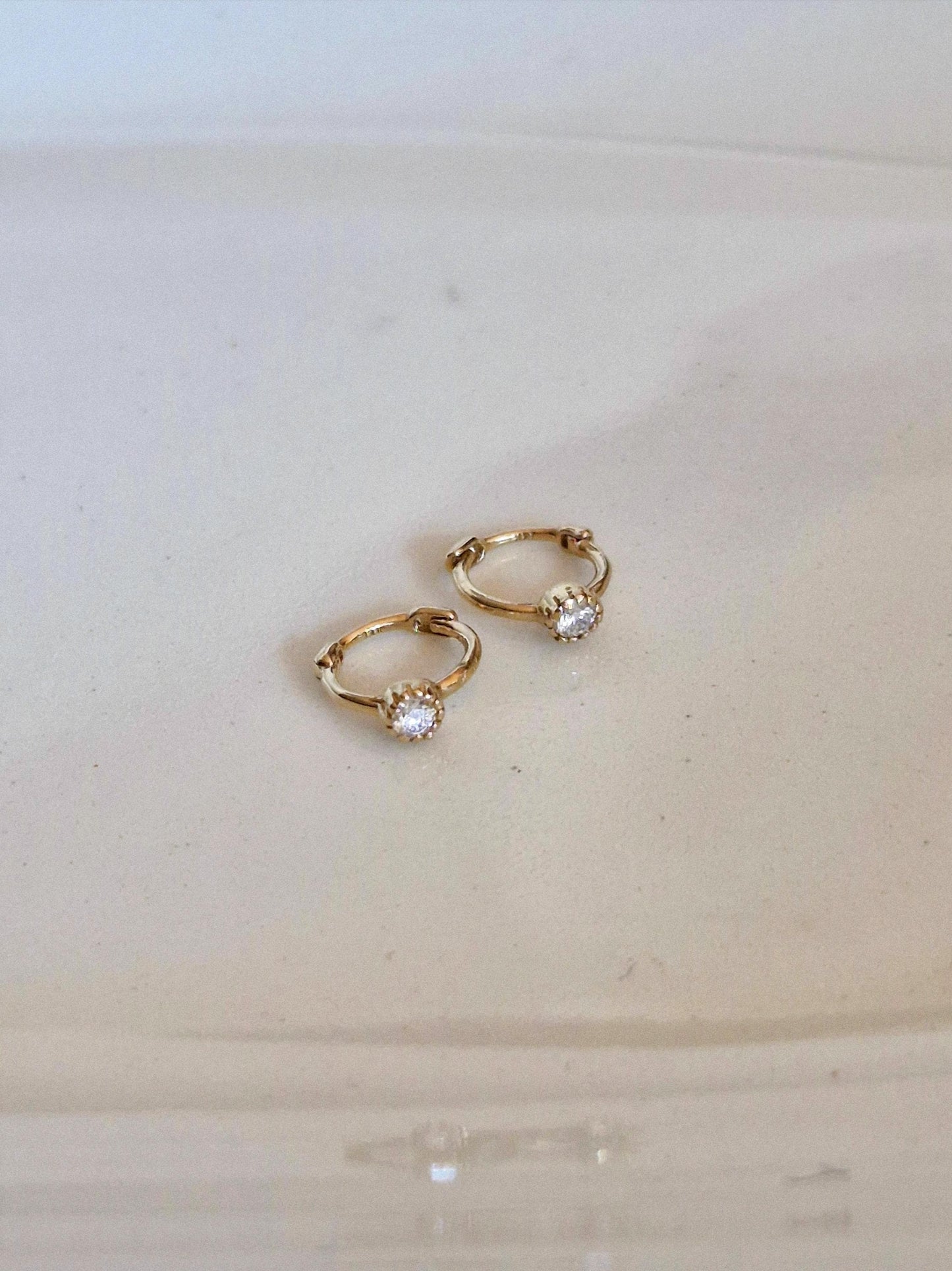 Tiny moisanite lab diamond 14k hoop earring.  solid gold hoop hinged clicker.