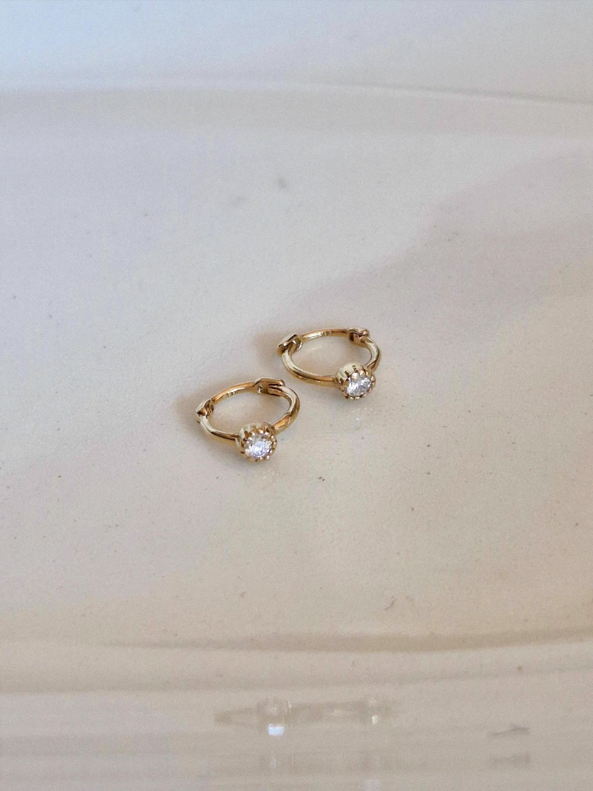 Tiny moisanite lab diamond 14k hoop earring.  solid gold hoop hinged clicker.