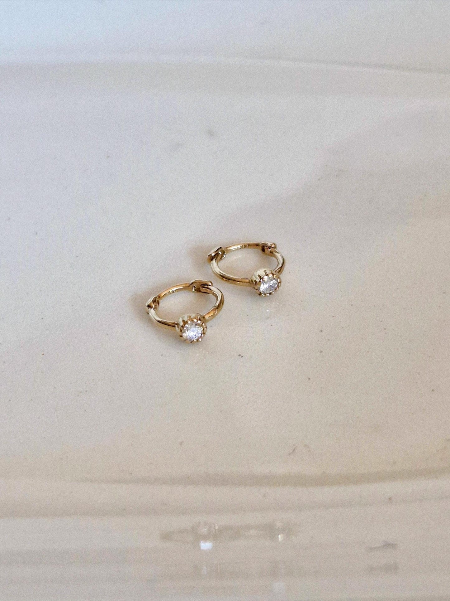 Tiny moisanite lab diamond 14k hoop earring.  solid gold hoop hinged clicker.