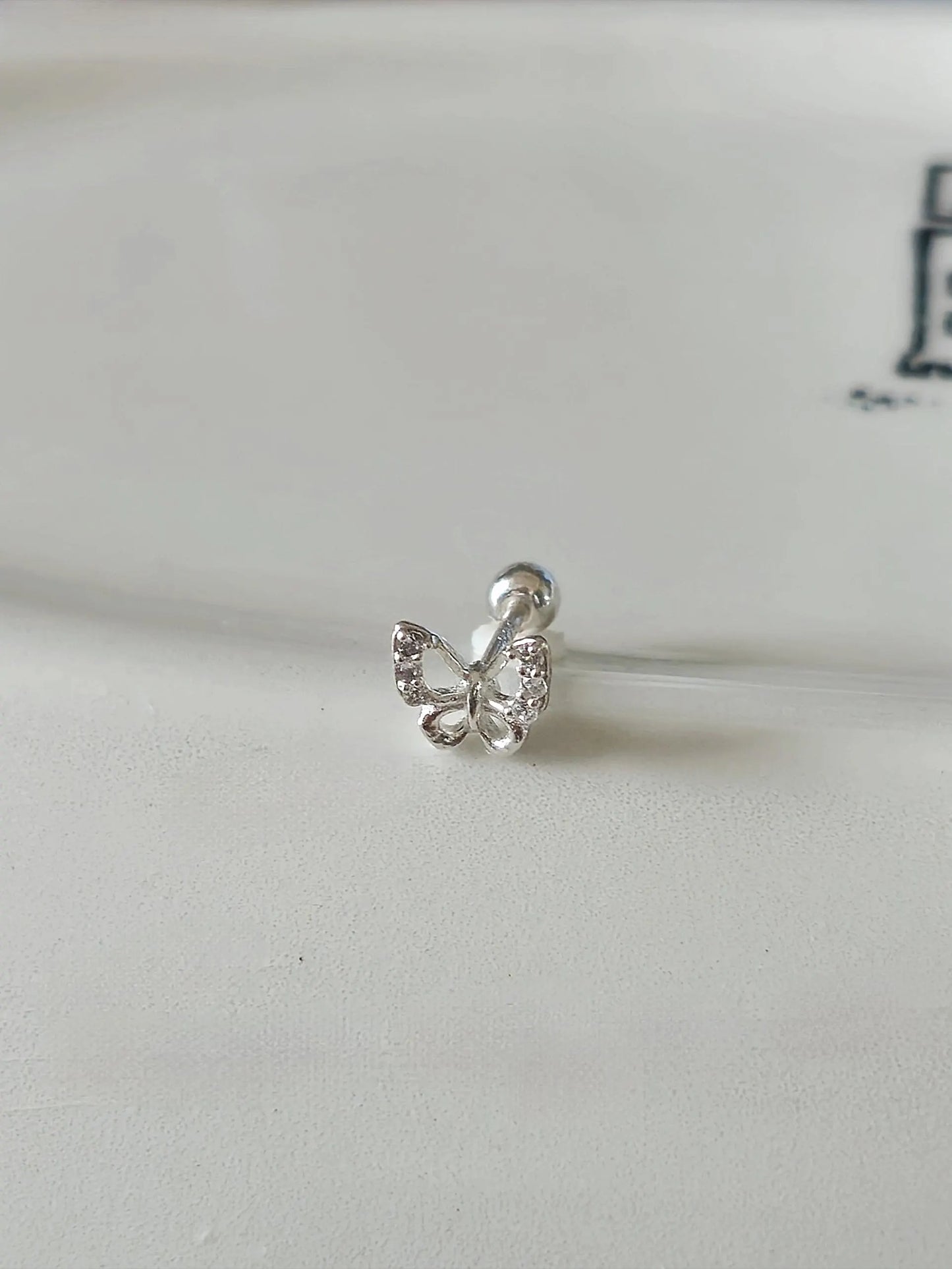 Sterling silver butterfly piercing. screwball stud.