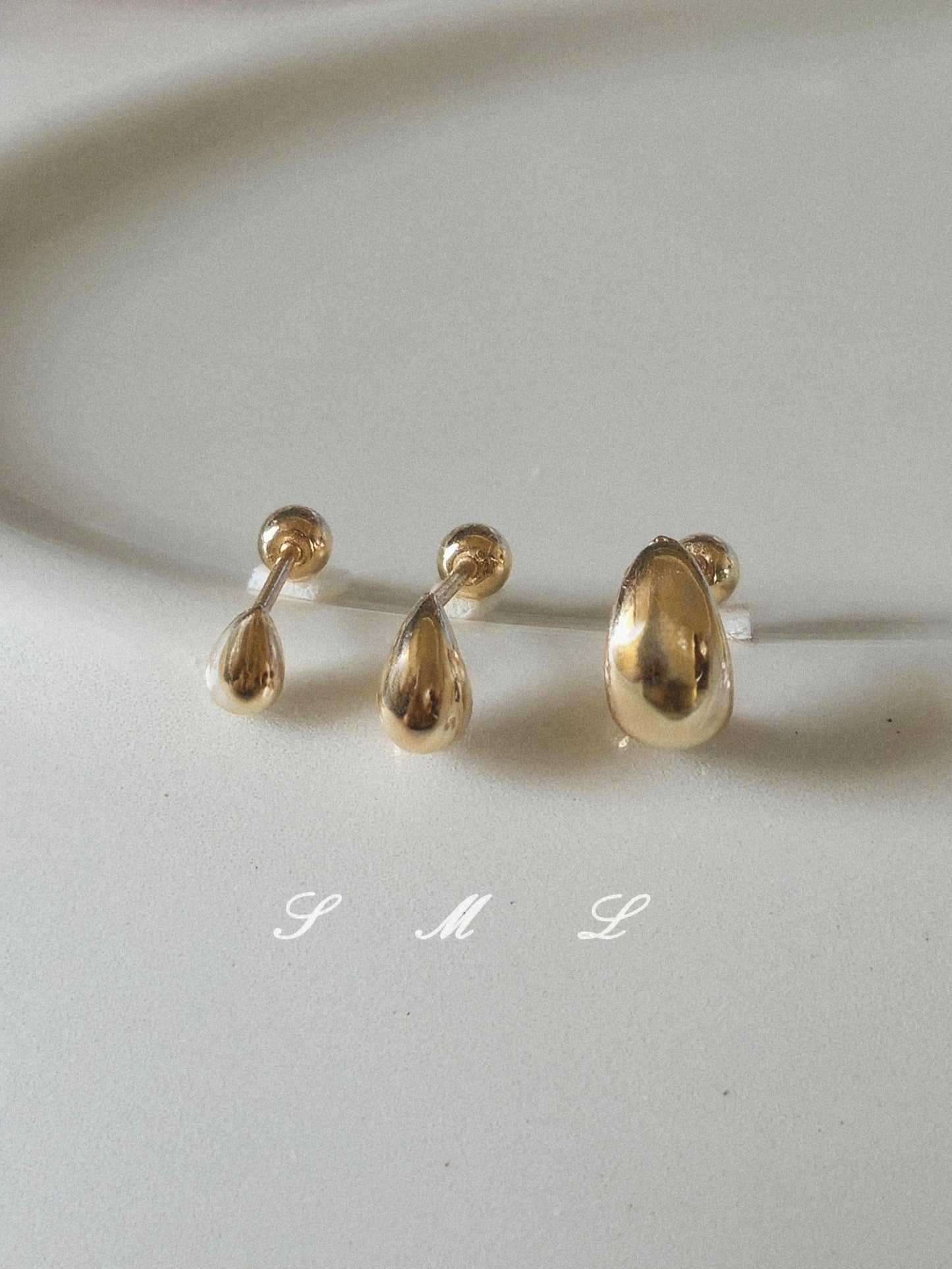 14k solid gold Teardrop screwball piercing. Teardrop piercing.