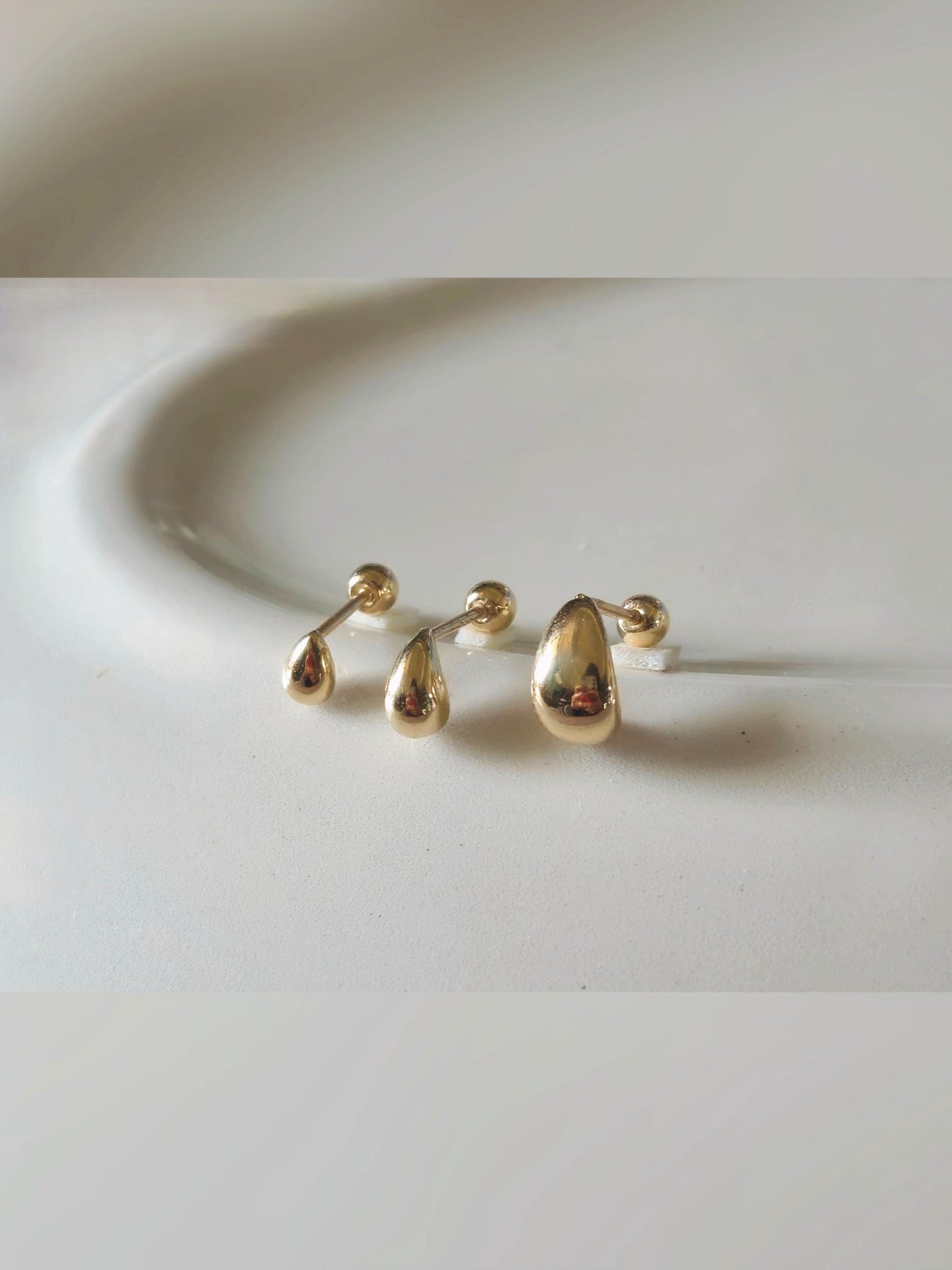 14k solid gold Teardrop screwball piercing. Teardrop piercing.