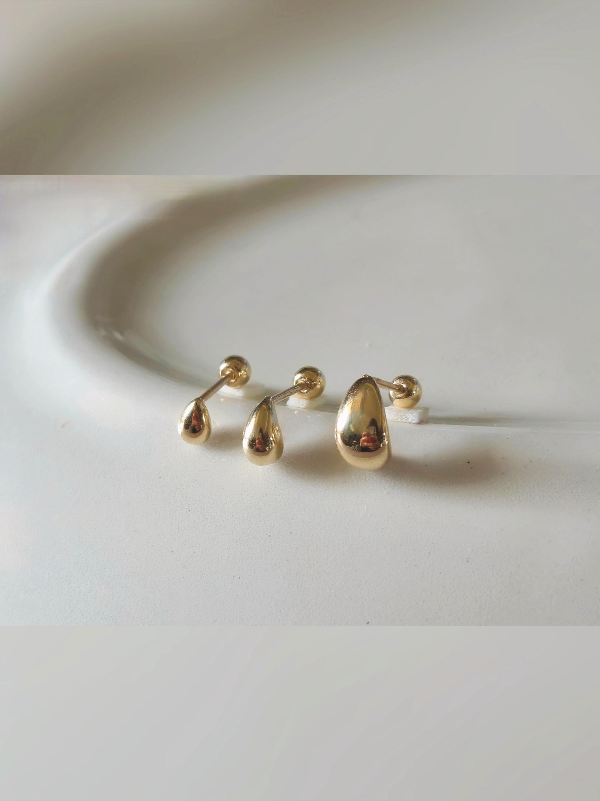 14k solid gold Teardrop screwball piercing. Teardrop piercing.