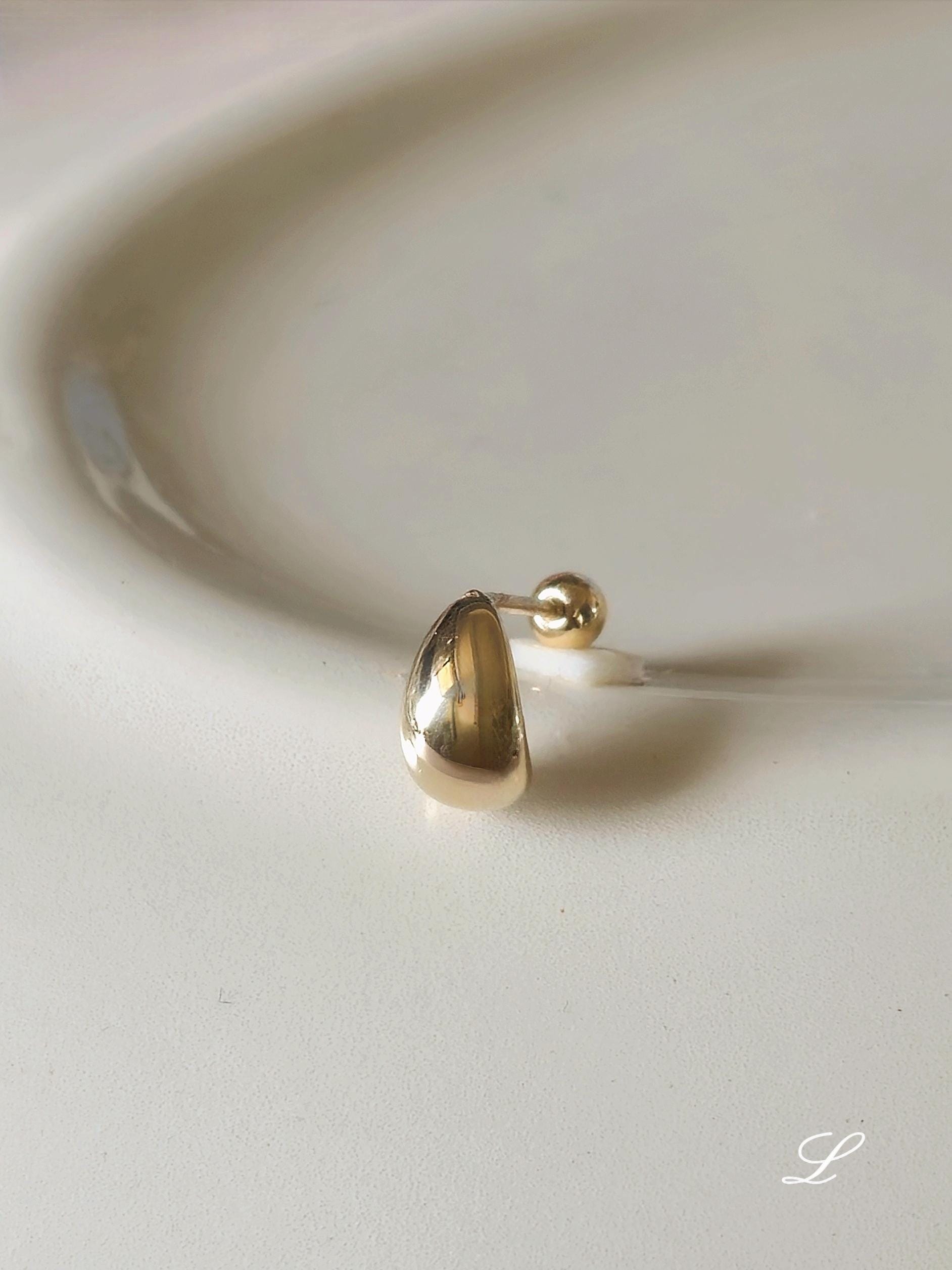 14k solid gold Teardrop screwball piercing. Teardrop piercing.