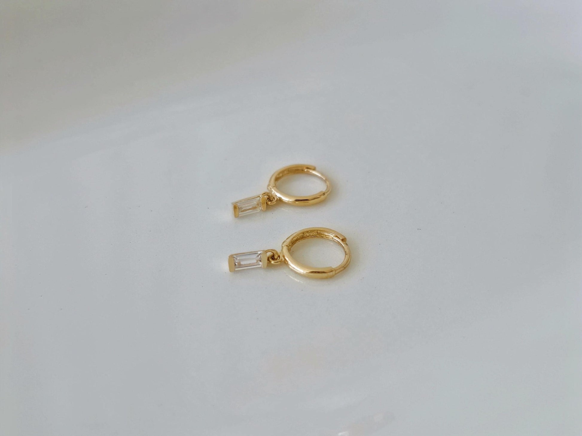 14k solid gold baguette cubic earrings. gold huggie earrings. Baguette drop earrings. Baguette dangle earrings.