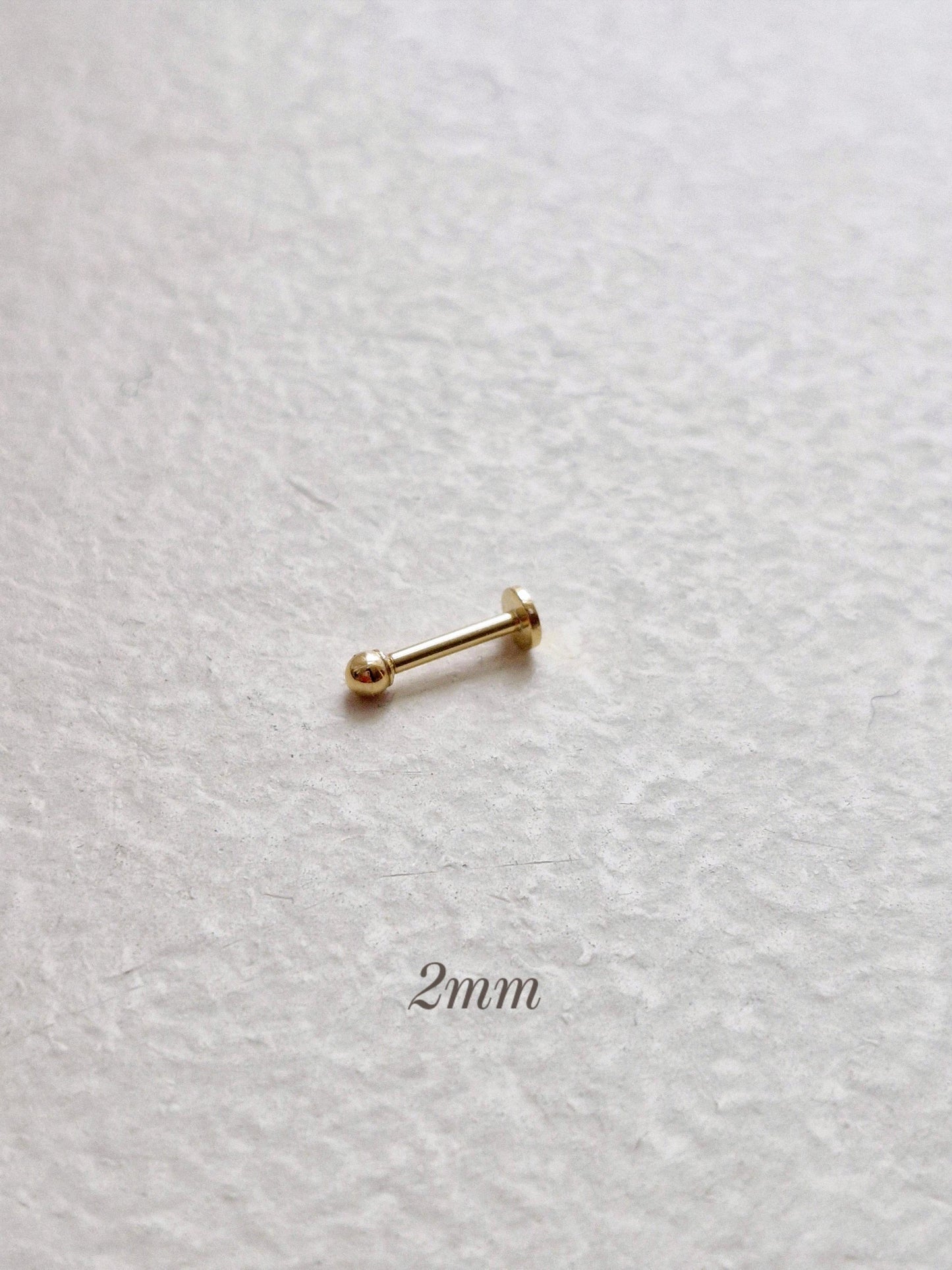 14k solid gold labret piercing. ball labret piercing. flat screw back.