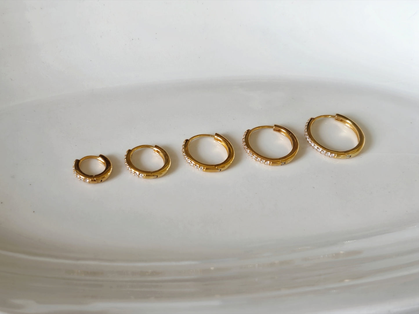 Sterling silver cubic pave hoop earrings.