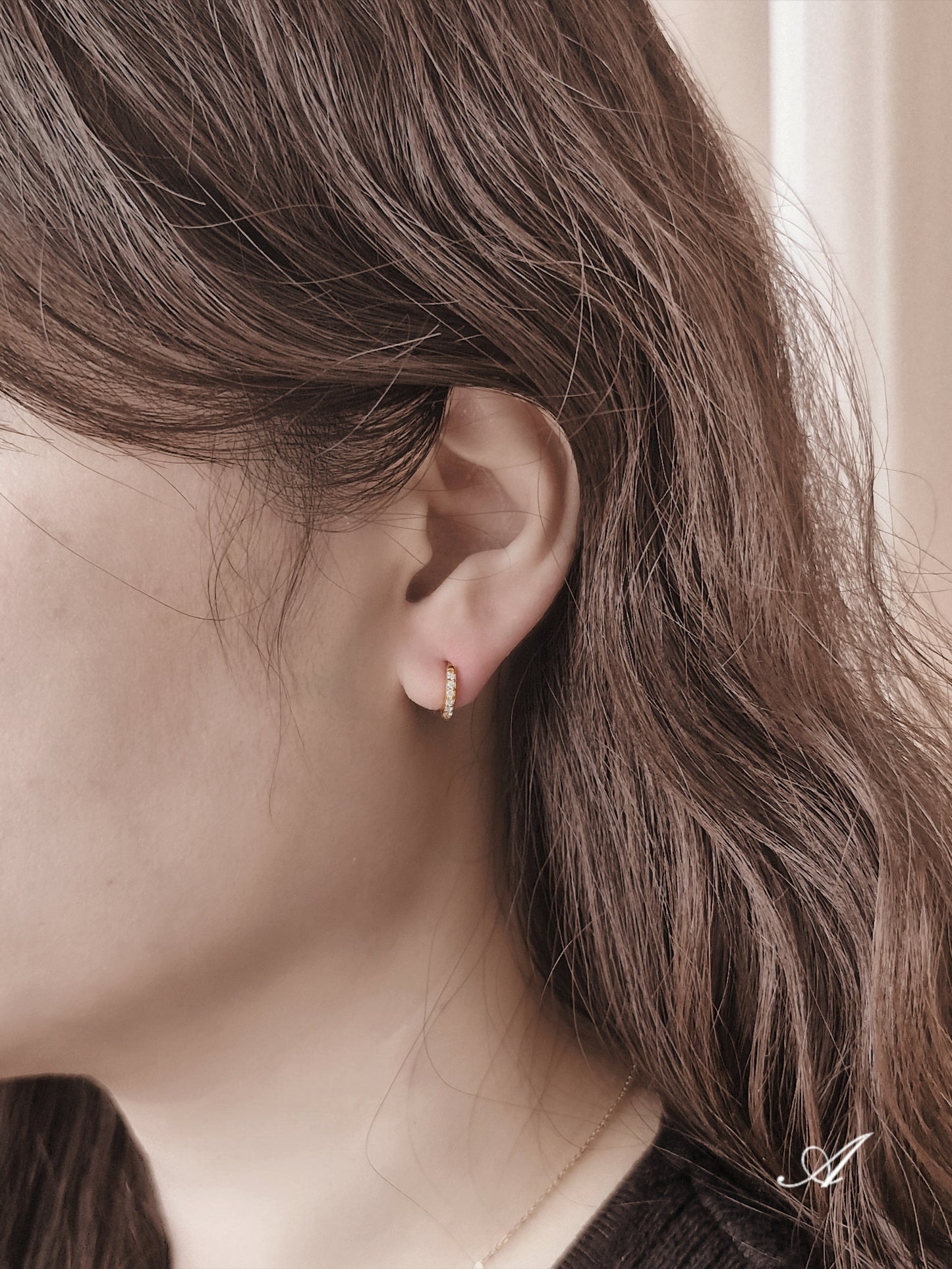 Sterling silver cubic pave hoop earrings.