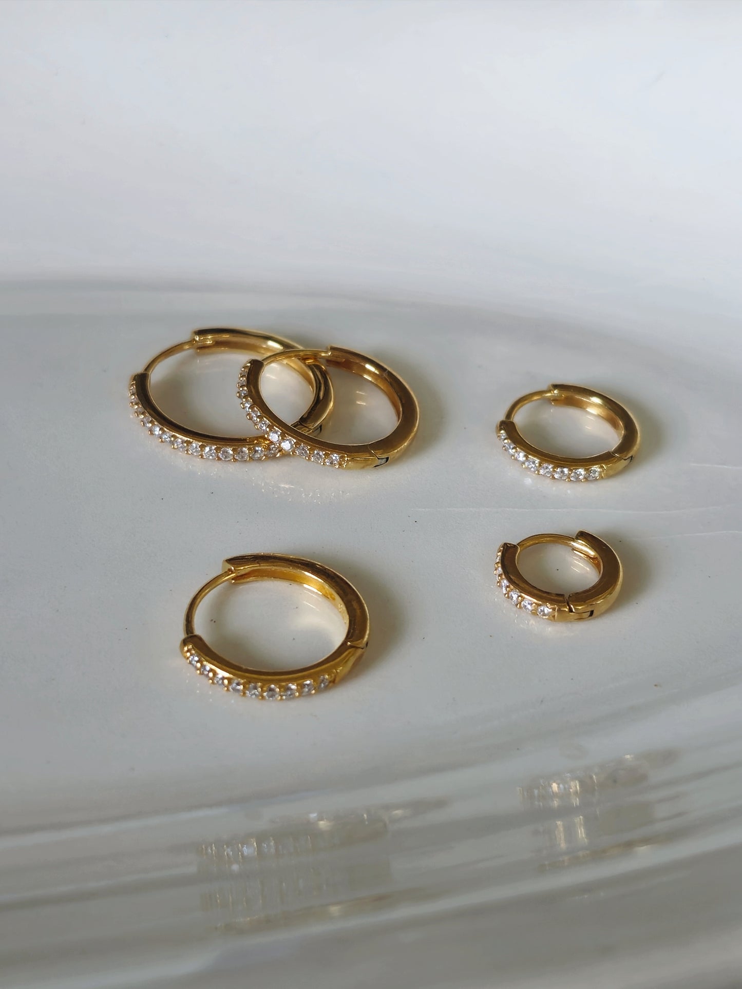 Sterling silver cubic pave hoop earrings.