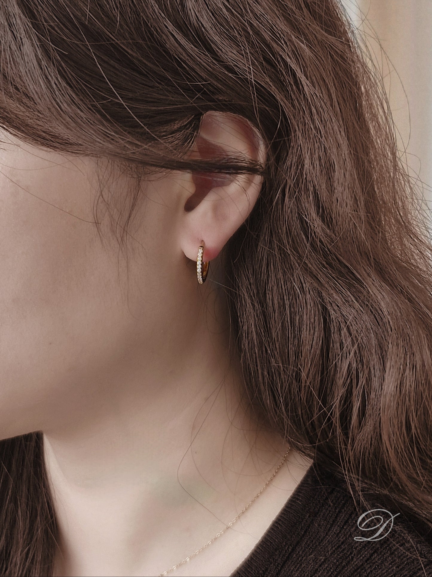 Sterling silver cubic pave hoop earrings.