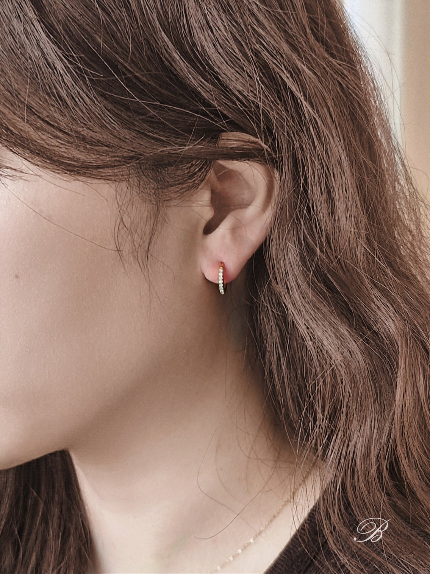 Sterling silver cubic pave hoop earrings.