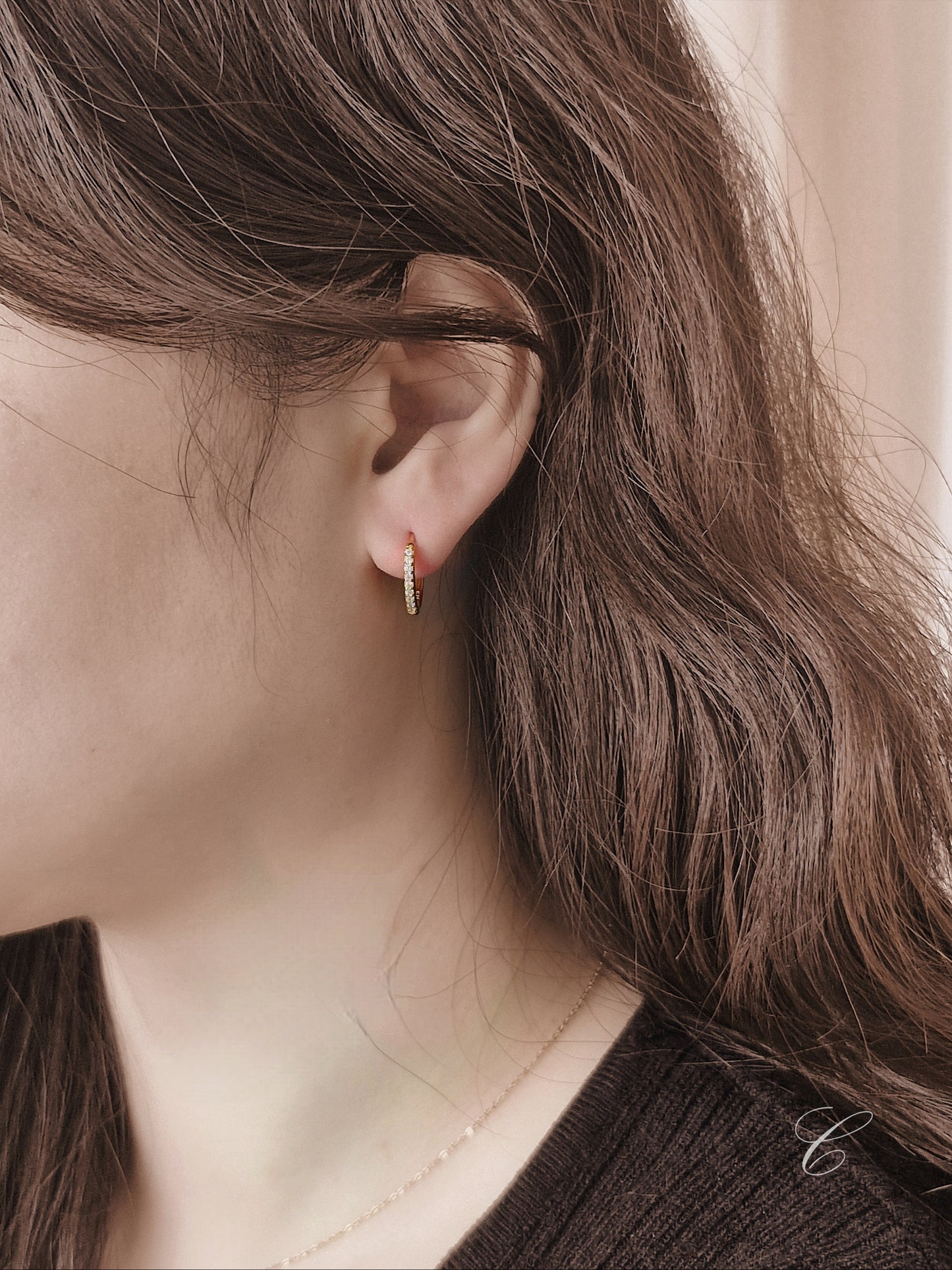 Sterling silver cubic pave hoop earrings.