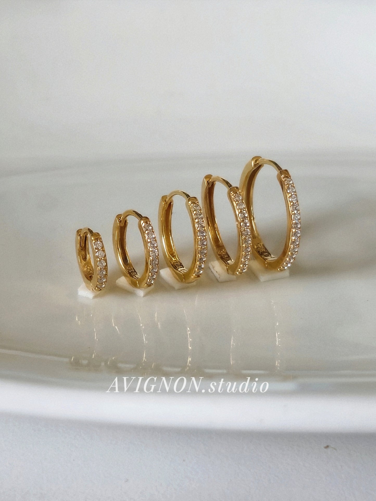 Sterling silver cubic pave hoop earrings.